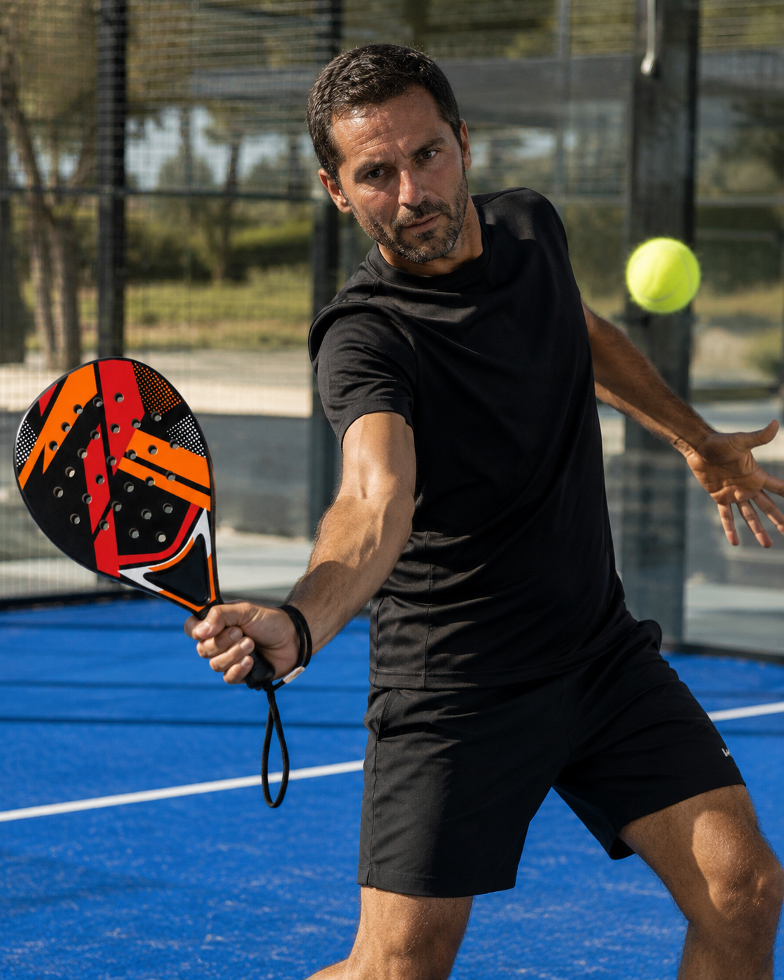 Joueur frappant une volée avec la raquette de padel LBS sur un court bleu